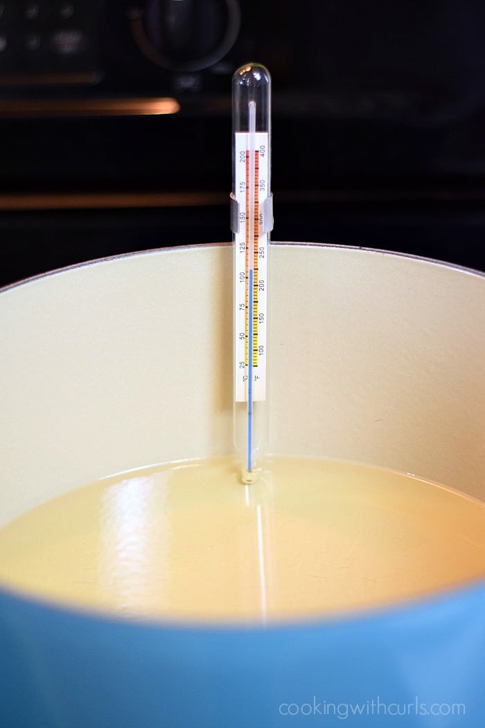 Oil and glass thermometer in a large Dutch oven.